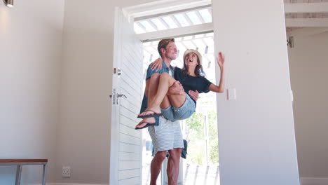 Man-Carries-Woman-Over-Threshold-Of-Honeymoon-Rental