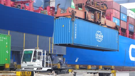 spreader lowering container onto loader at karachi port trust terminal