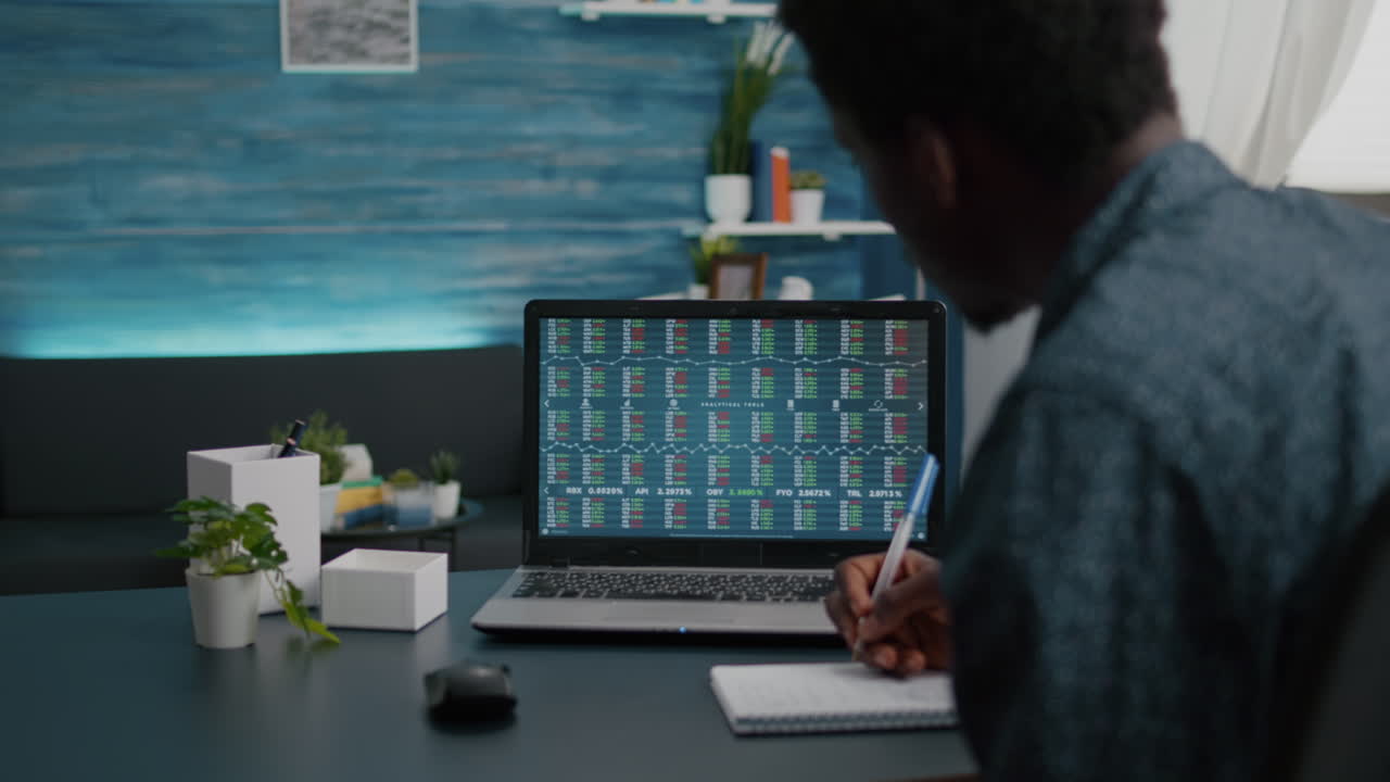 African american man crypto currency stock markets trader checking stock ticker index