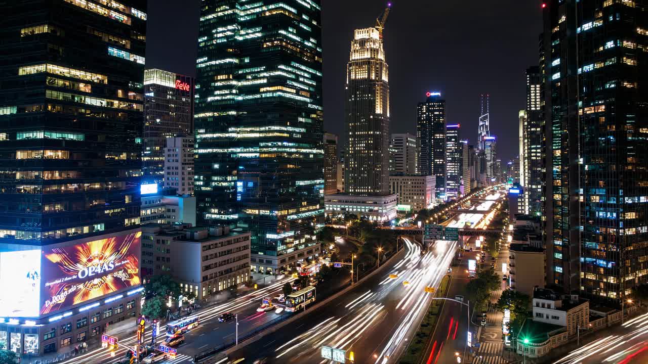 Nighttime cityscape video with a high-angle view, capturing light trails from traffic