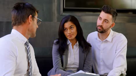 Couple-discussing-over-agreement-with-broker-on-sofa-4k