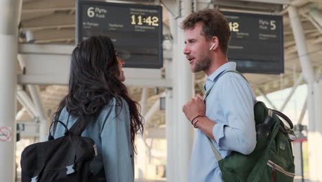 couple waiting for train at station