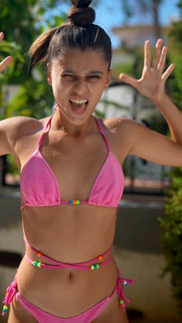 teenage girl in pink bikini outdoors