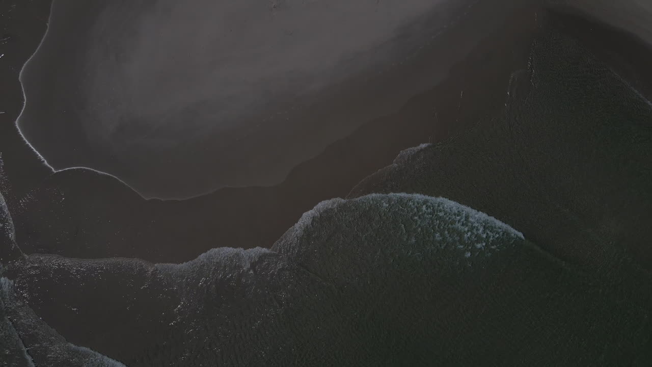 Green ocean water on a temporary sand mound