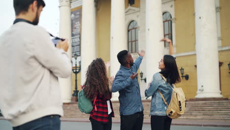 friends taking a photo in front of a building