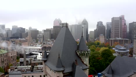 Aerial-shot-of-Montreal's-downtown-skyline-and-McGill's-university-on-a-foggy-fall-morning