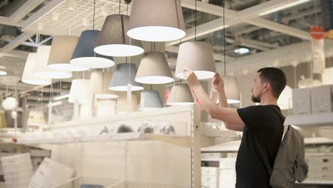 customer browsing pendant light display in a home goods store