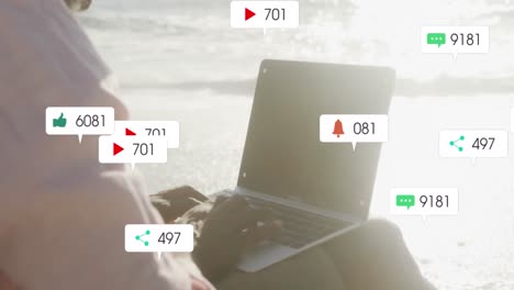 Animation-of-notification-icons-with-numbers-over-african-american-woman-using-laptop-at-beach