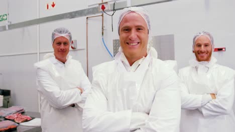 Team-of-smiling-butcher-standing-with-arms-crossed