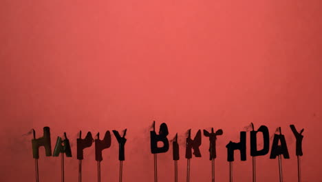 silhouette of happy birthday candles being extinguished