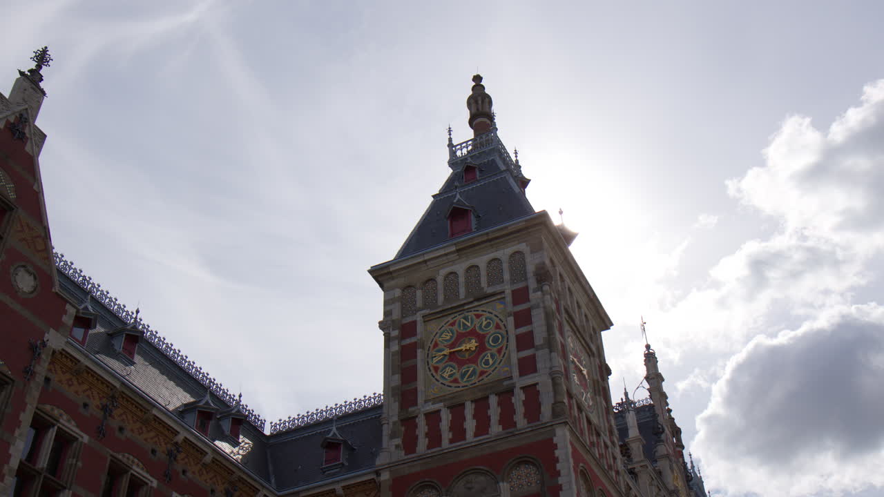 Clock Tower On Amsterdam Centraal Station, Railway Station In Amsterdam, North Holland, The Netherlands. Low angle shot