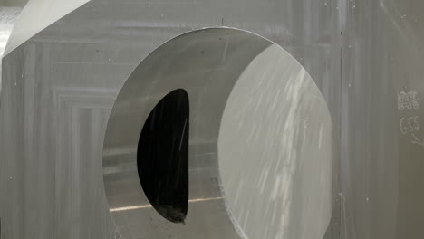 close-up view of a metal component with a machined hole