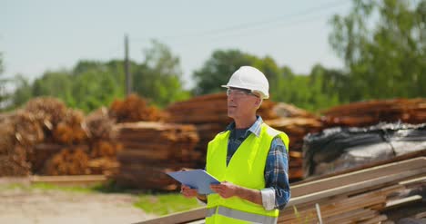 Male-Worker-Examining-Plank'S-Stack-23