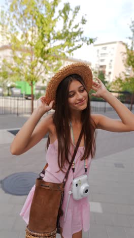 young woman with a straw hat and a camera