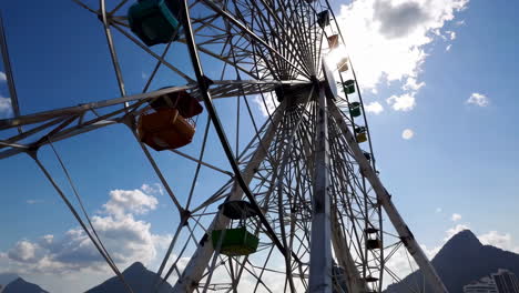ferris wheel on a sunny day with blue sky and sunburst