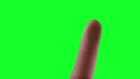 caucasian man pointing on green background