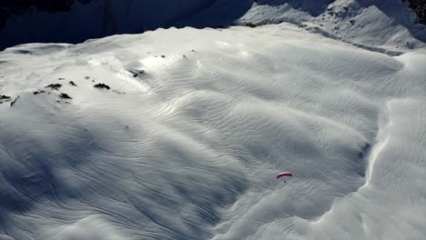 paragliding by drone in winter from above - scenic mountain shot val d'isere