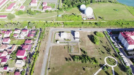 aerial view of suburban residential area with industrial and military elements