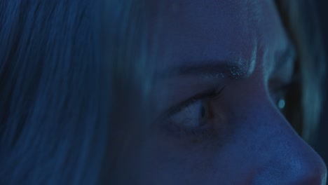 Macro-of-a-beautiful-woman's-eyes-looking-around-in-a-dark-room