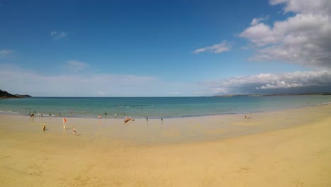 A-drone-takes-off-from-a-beautiful-secluded-beach-at-Carbis-bay,-Cornwall,-Penzance,-Beautiful-yellow-sand-and-lovely-see-through-oceans