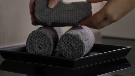 housekeeper placing clean towels in hotel room