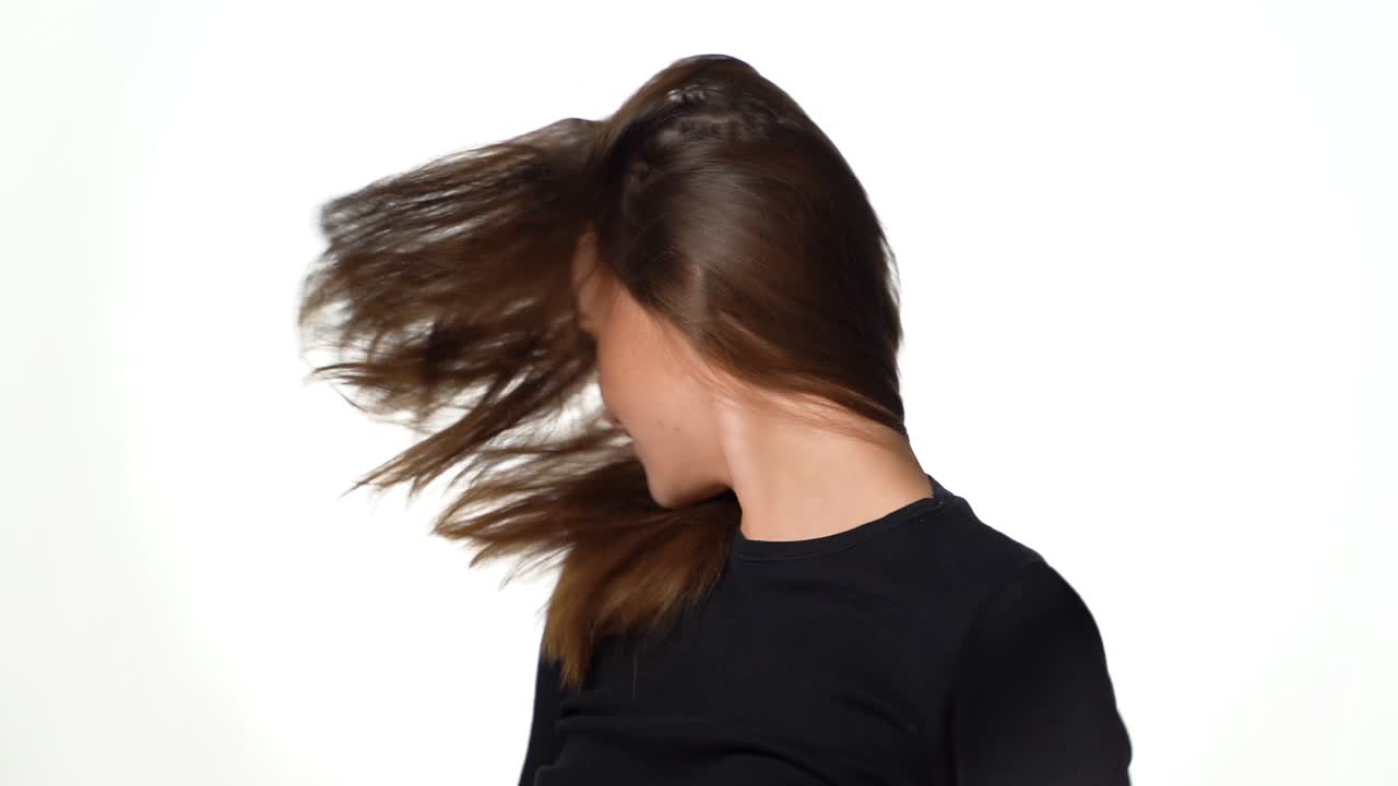 Graceful model with gorgeous hair poses for the camera in the studio on a white background. Close-up