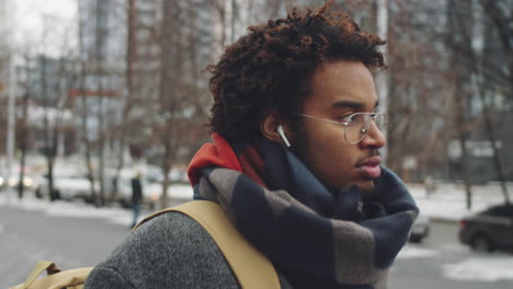 young man walking in the city in winter