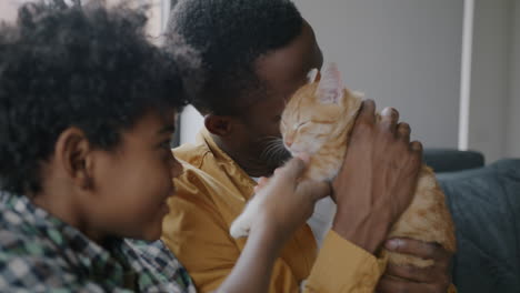 father and son with a cat