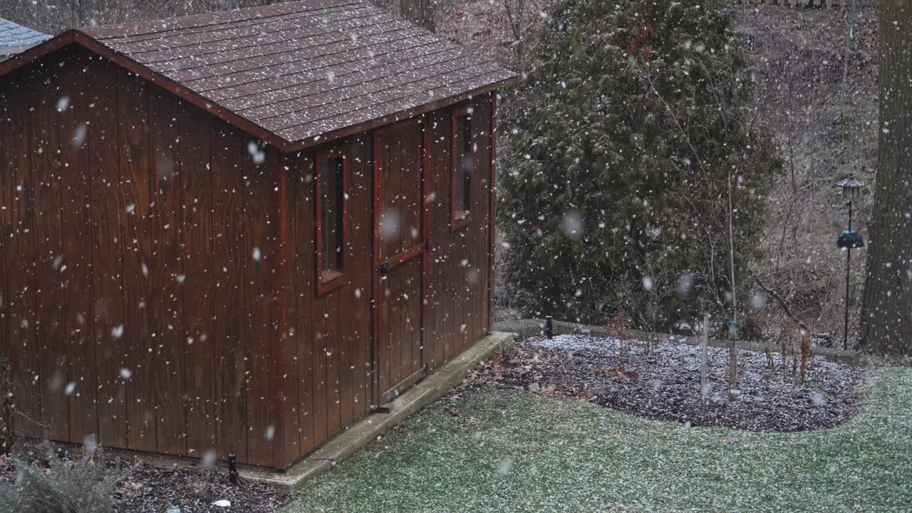 First Snowfall of the Year Over Wooden Shed, Slow Motion High Angle