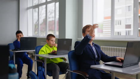 students in a classroom with laptops