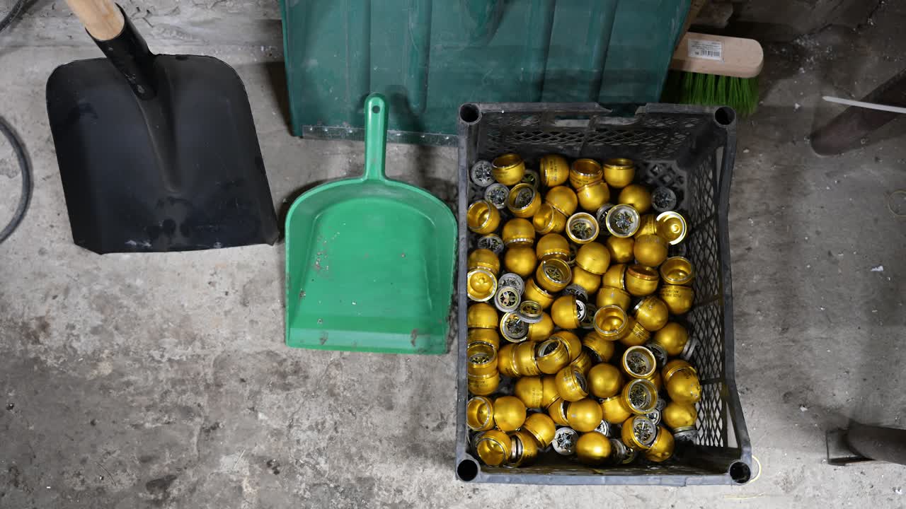 A crate of grenade casing leftovers is seen at a drone workshop in Ukraine's Donetsk region. Highlighting adaptive weapon production for combat