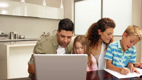 family spending time together with the laptop and drawing
