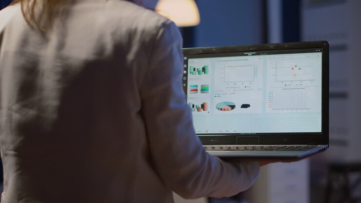 Close up of woman typing on laptop standing in start up office