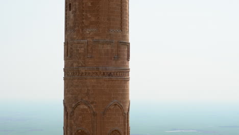 the camera scans the minaret of the historical mardin ulu mosque, from the bottom up