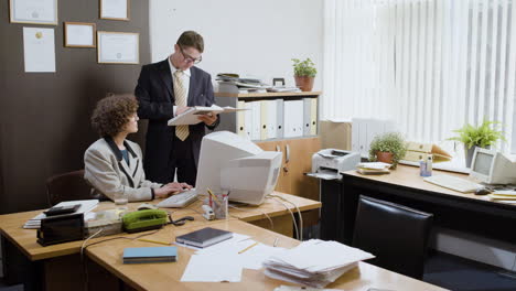 woman using a retro computer in vintage office.