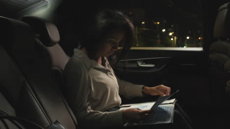 business lady doing paperwork at backseat