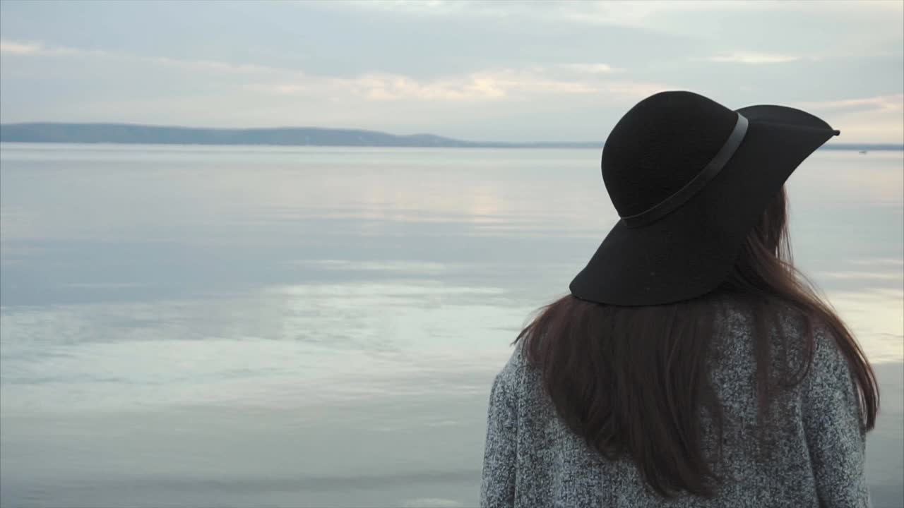 Woman by the lake at sunset