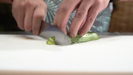 chef cutting zucchini in slow motion