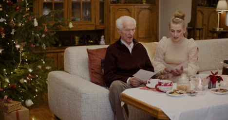 Grandfather-And-Granddaughter-Caroling-At-Home-2