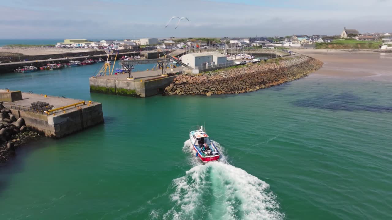 4K cinematic drone footage capturing Kilmore Quay, on a bright day, showcasing the picturesque harbour, and colourful fishing boats Co.Wexford - Ireland_012