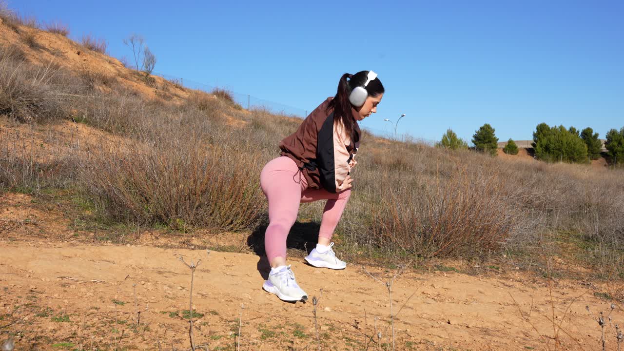 joven en forma estirando secuestradores en el parque después de correr