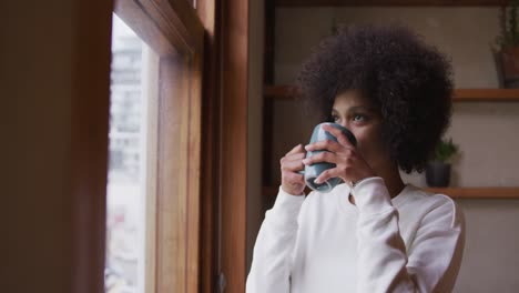 mixed race woman drinking coffee