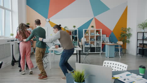 happy office team dancing