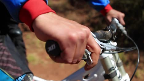 andar en bicicleta con las manos en el agarre comprobando los descansos