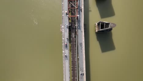 residents commuting along the imposing long bien bridge in hanoi, aerial