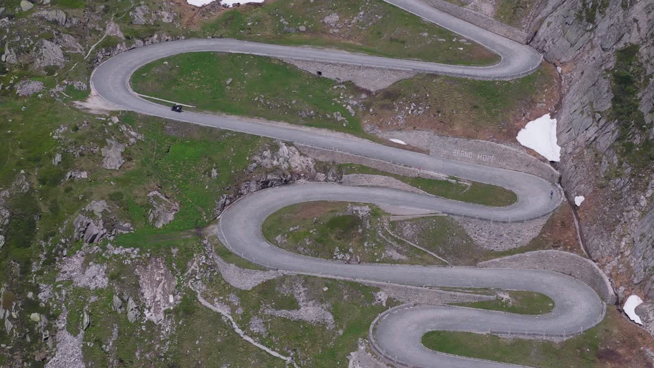 Compressed drone view showing repeated tight curves stacked along steep valley