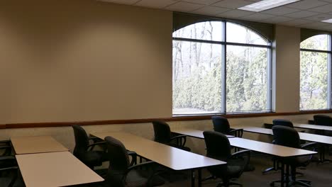 empty classroom tables and chairs window view
