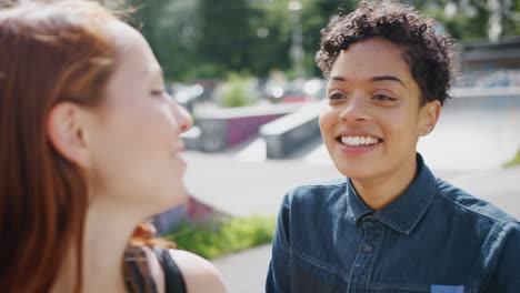 Two-Female-Friends-Meeting-In-Urban-Skate-Park