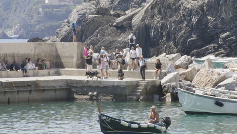 people at the port of vernazza in cinque terre in liguria coast, italy. static shot