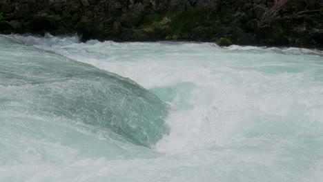 a waterfall with a large amount of water on a clean and wild mountain river